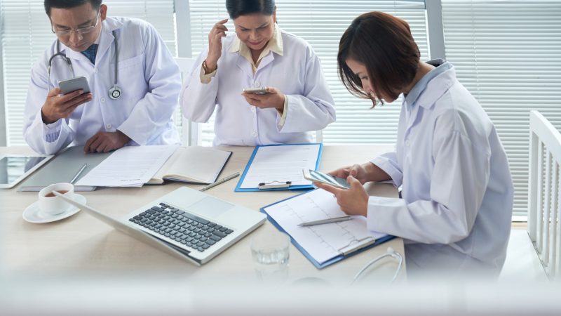 three-doctors-busy-using-their-gadgets-scaled.jpg